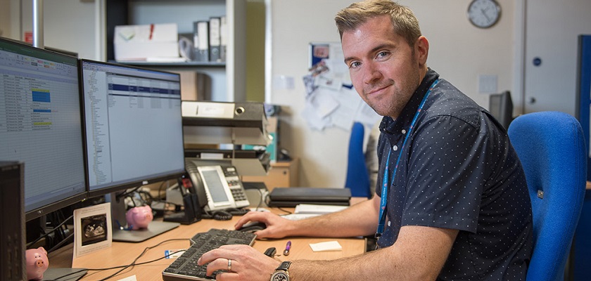 A member of administrative support smiling.