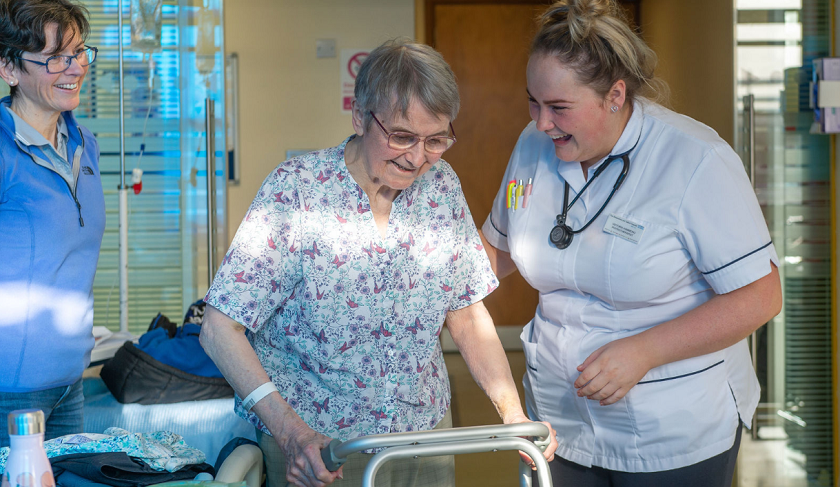 Nurse helping patient to walk 