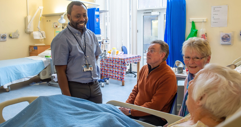 Doctor speaking to patient and patient's family