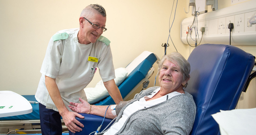 Male nurse taking blood pressure of patient