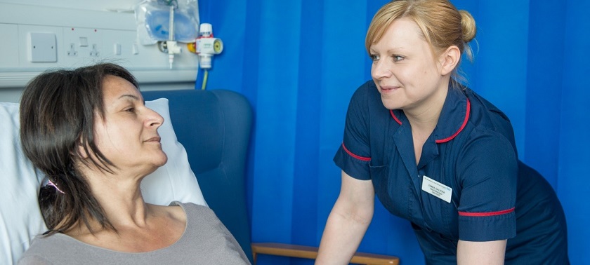 A nurse speaking with a patient