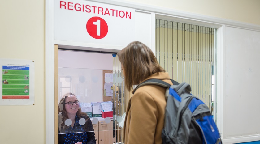 Patient talking to female receptionist