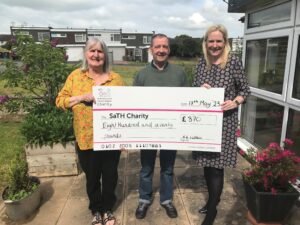 Ernest and Hannah Morris holding the big SaTH Charity Cheque