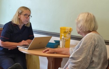 Care Home resident Julie Hayes receiving her vaccination from Linda Hart, Clinical Team Lead