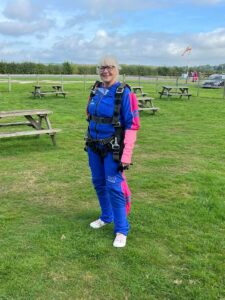 An image of Dementia Nurse Karen Breese preparing for her paracute jump