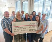 Pictured - Neville Street, Sonia Philippou and Georgia Page with the Chemo Day Care unit team holding a big cheque
