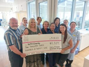 Pictured - Neville Street, Sonia Philippou and 
Georgia Page with the Chemo Day Care unit 
team holding a big cheque