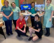 An image of staff from the children's ward and two of the gaming carts that were purchased.