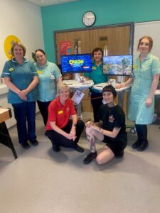 An image of staff from the children's ward and two of the gaming carts that were purchased.