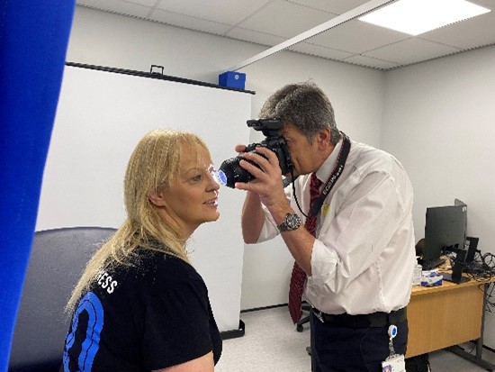 Professional Clinical Photographer taking a close up image of patients cheek