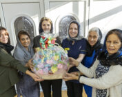 Penny Watson and Miriam Gilbert from SaTH's palliative and end of life care team with ladies from the knitting group and Gillian Denning