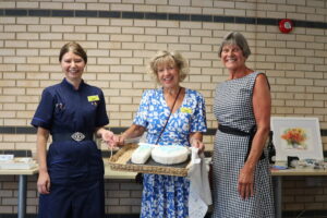 Jules Lewis, Julia Clarke and Jules Lock with the cake.