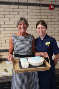 Jules Lock Lead Swan EOLC Volunteer and Jules Lewis End of Life Care Facilitator/Lead Nurse with the cake