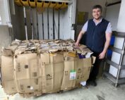 Jake Mound-Evans, a Chargehand Porter, with one of the cardboard bales