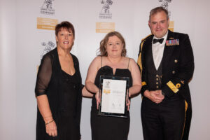 Commodore Tristram Kirkwood presents Sarah Millington and Lisa Walker with the Gold award