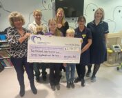An image of Henrietta and staff from Shrewsbury and Telford Hospital NHS Trust holding the big charity cheque