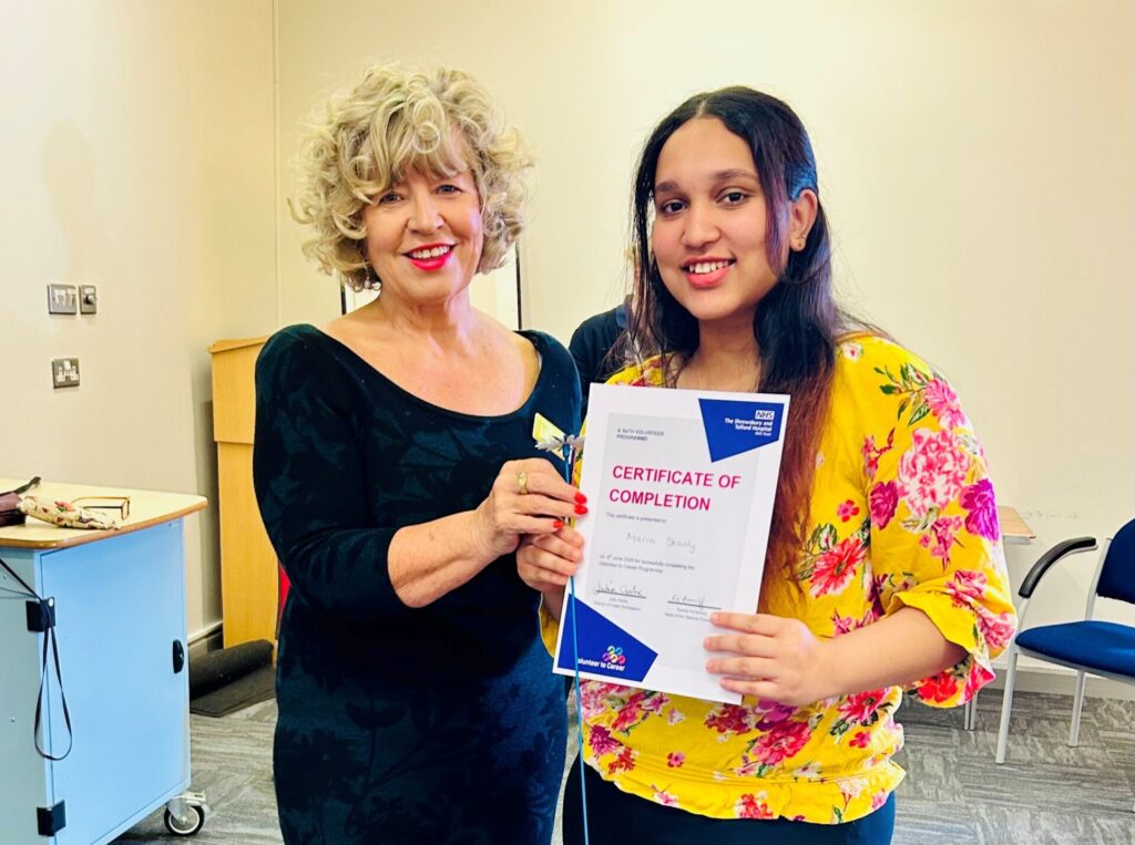 Julia and Maria Stanly Image of Julia Clarke, Director of Public Participation, giving a certificate of completion to a VTC candidate