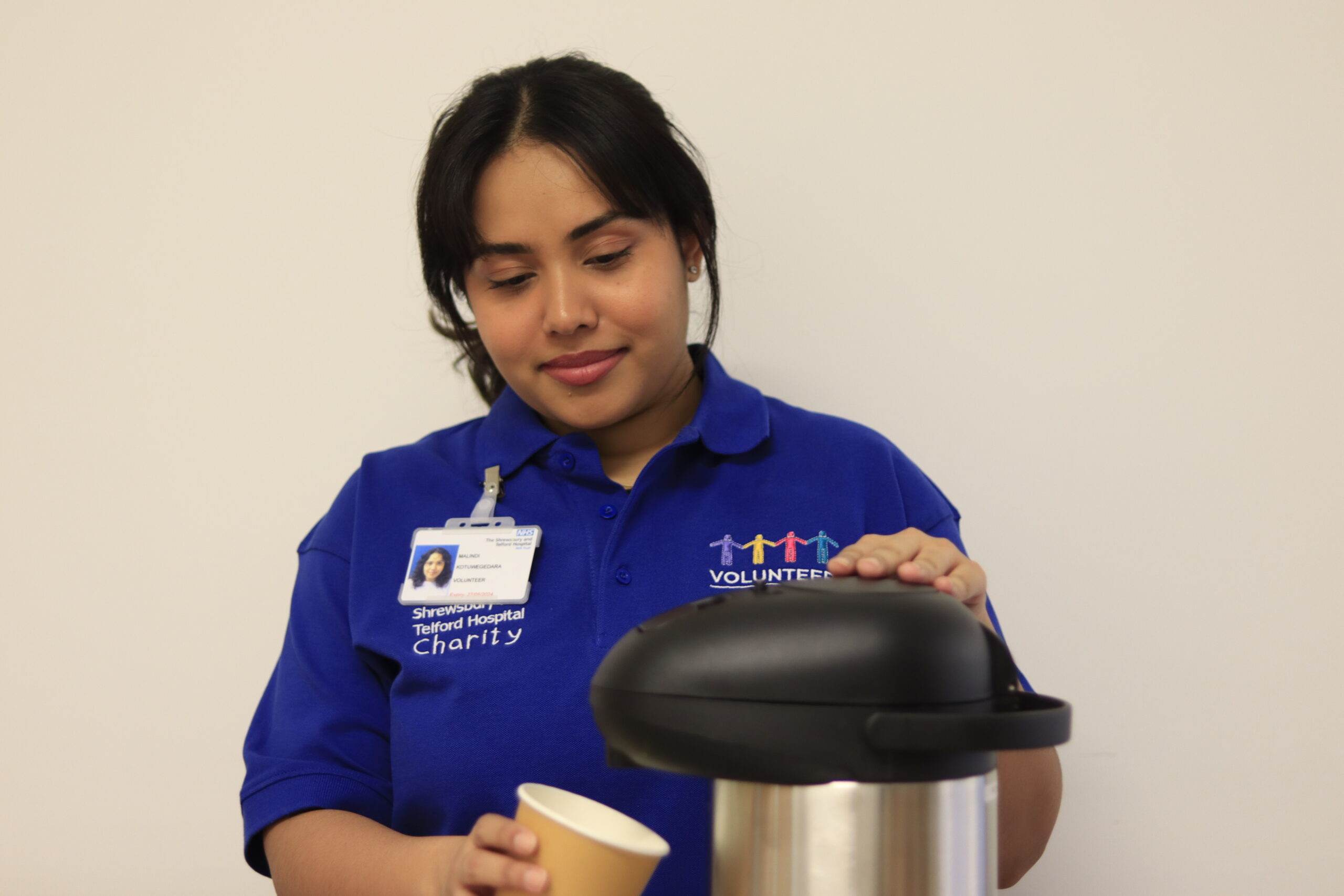 Image of a volunteer making a hot drink